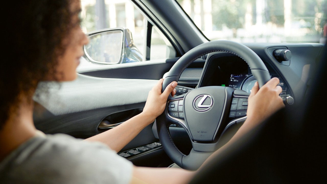 A woman driving a Lexus