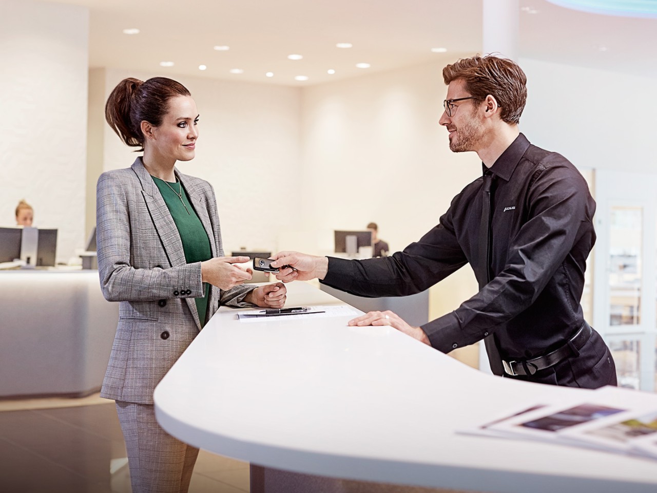 A Lexus employee handing over some Lexus keys