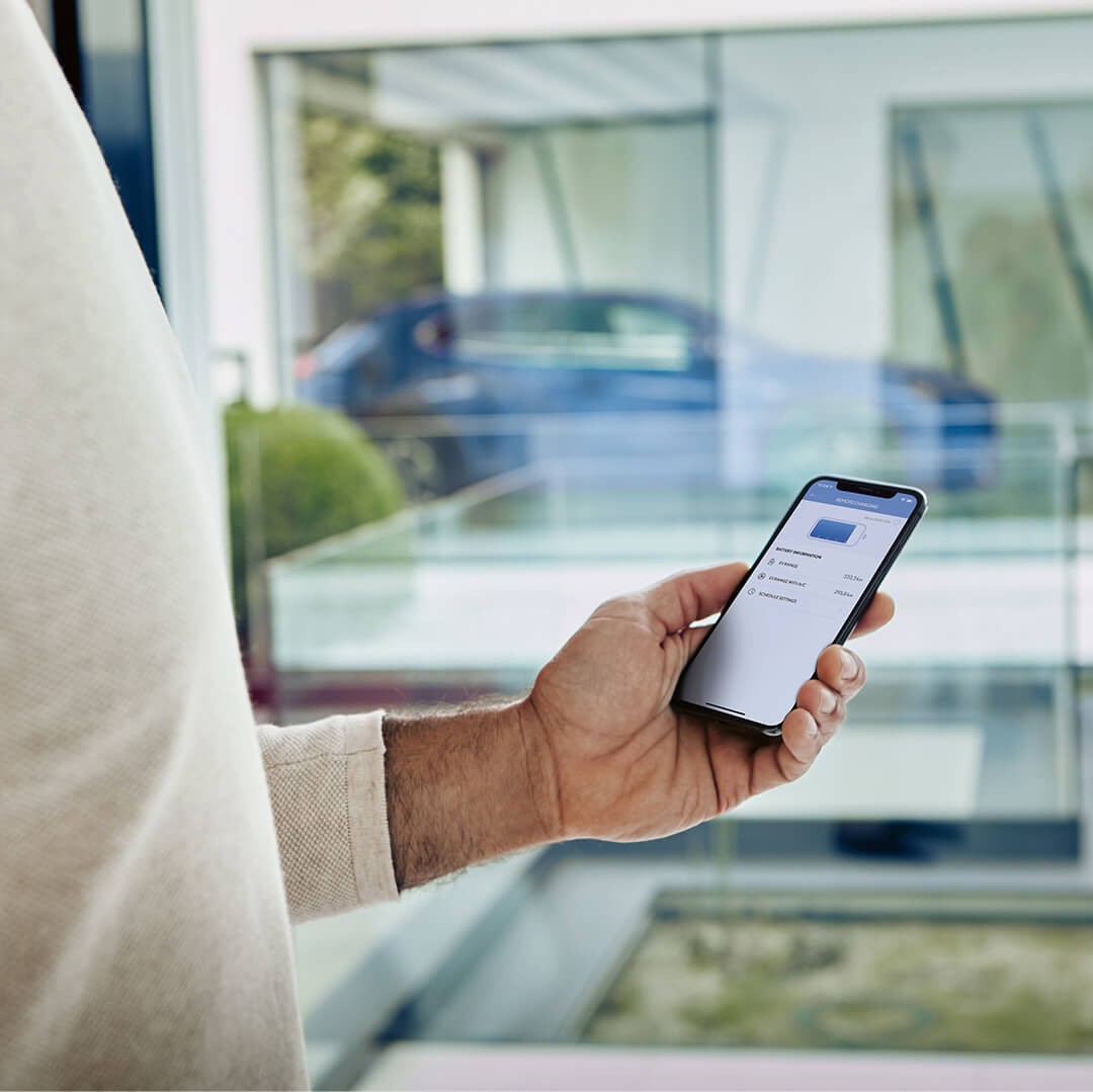 A man using a mobile phone to access the Lexus Link app