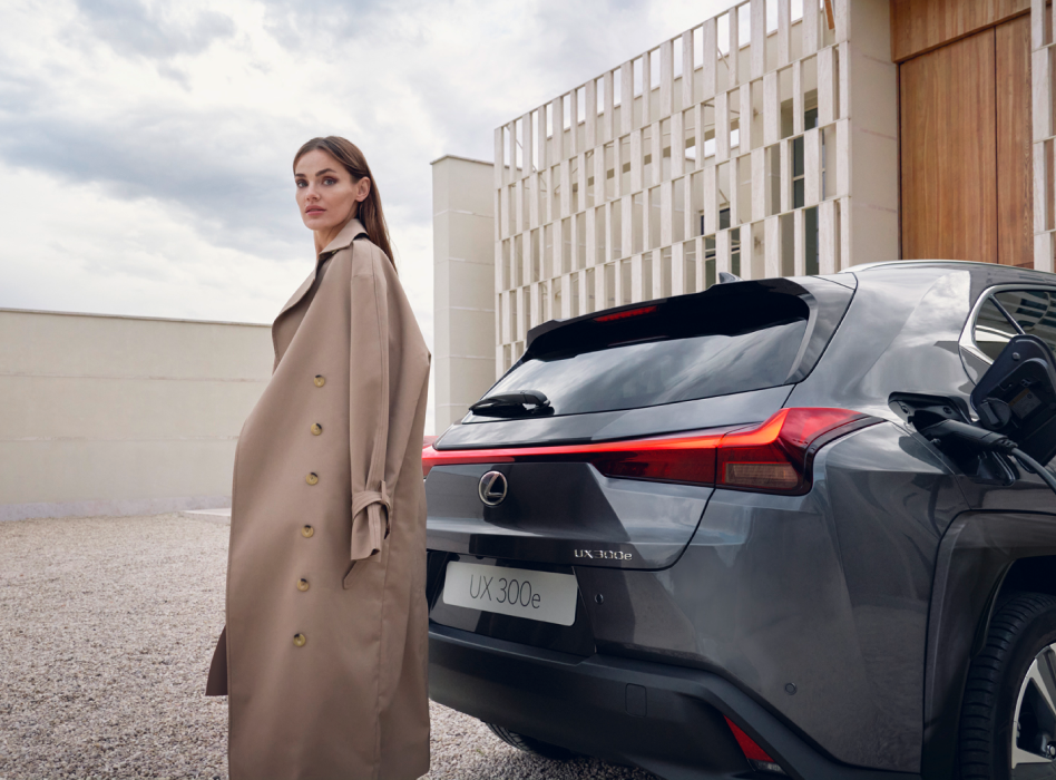 A person stood next to a Lexus UX 300e