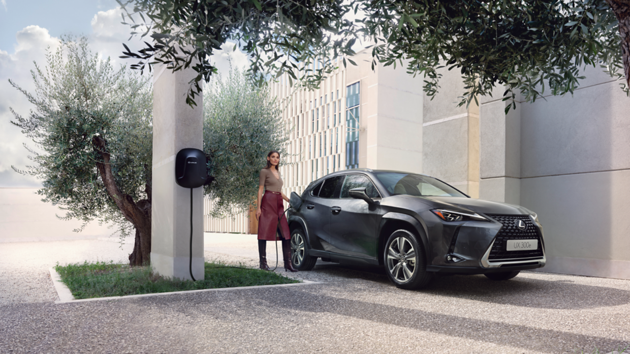 A person plugging in a charging socket into a Lexus UX 300e