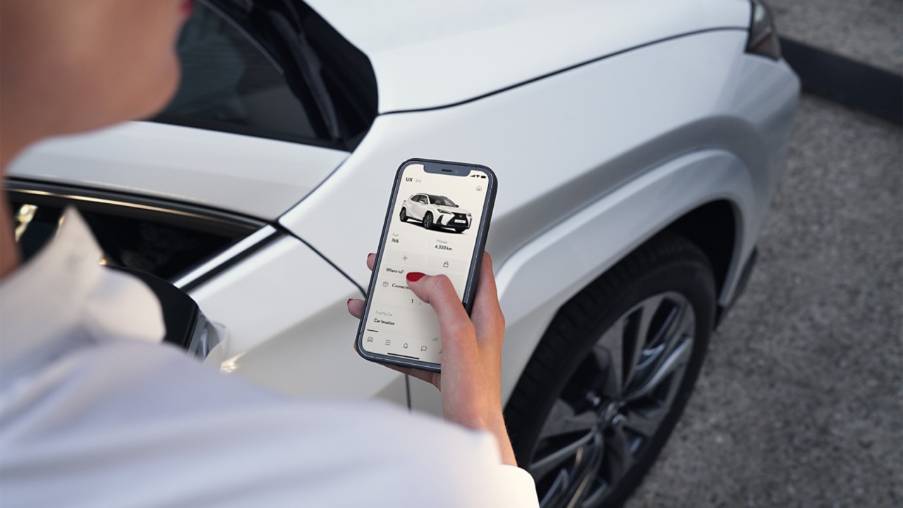 A man using a mobile phone to access the Lexus Link App